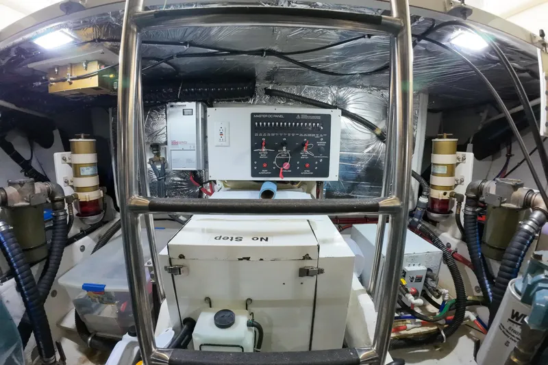 Sun Baked Yacht Photos Pics Engine room of 1999 Tiara Yachts 3500 Express with control panel and equipment.