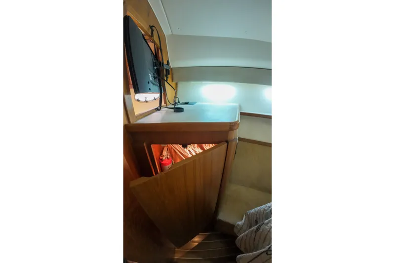 Sun Baked Yacht Photos Pics 1999 Tiara Yachts 3500 Express interior with wooden cabinetry and modern lighting.