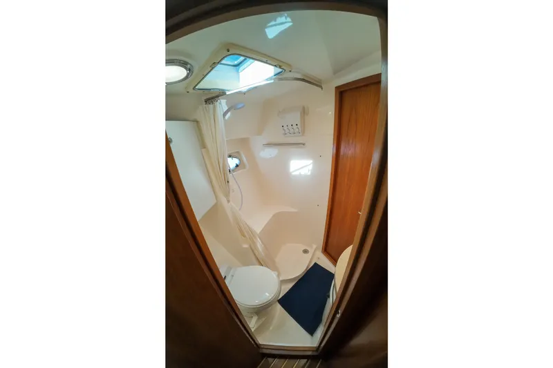 Sun Baked Yacht Photos Pics Bathroom interior of 1999 Tiara Yachts 3500 Express with shower and toilet.