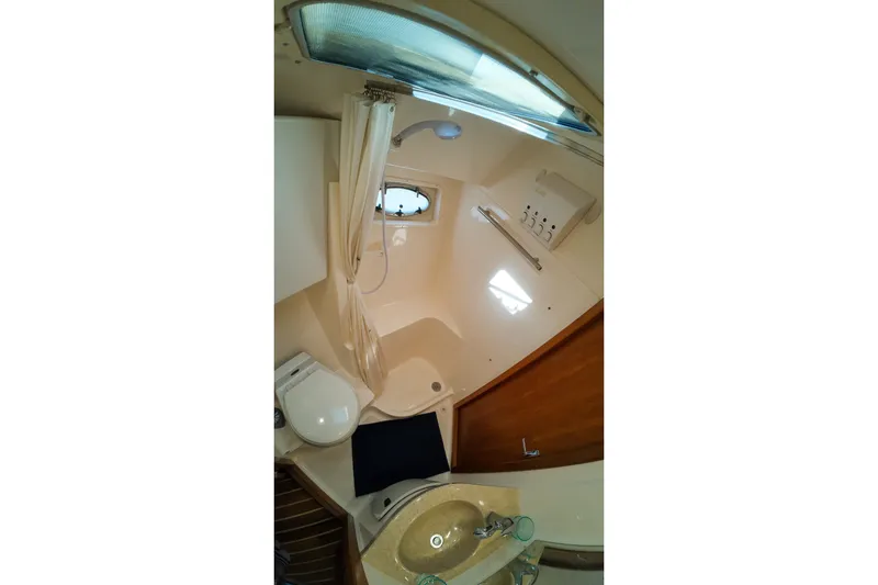 Sun Baked Yacht Photos Pics 1999 Tiara Yachts 3500 Express bathroom with shower, sink, and toilet.