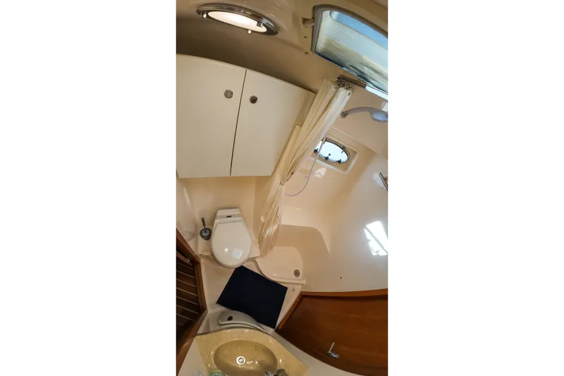 Sun Baked Yacht Photos Pics 1999 Tiara Yachts 3500 Express bathroom with shower, sink, and toilet.