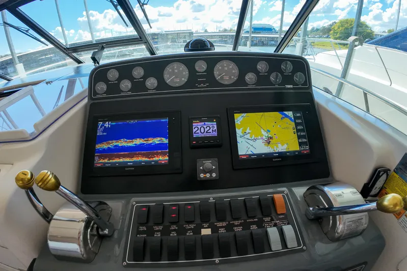 Sun Baked Yacht Photos Pics Control panel of a 1999 Tiara Yachts 3500 Express with navigation displays and gauges.