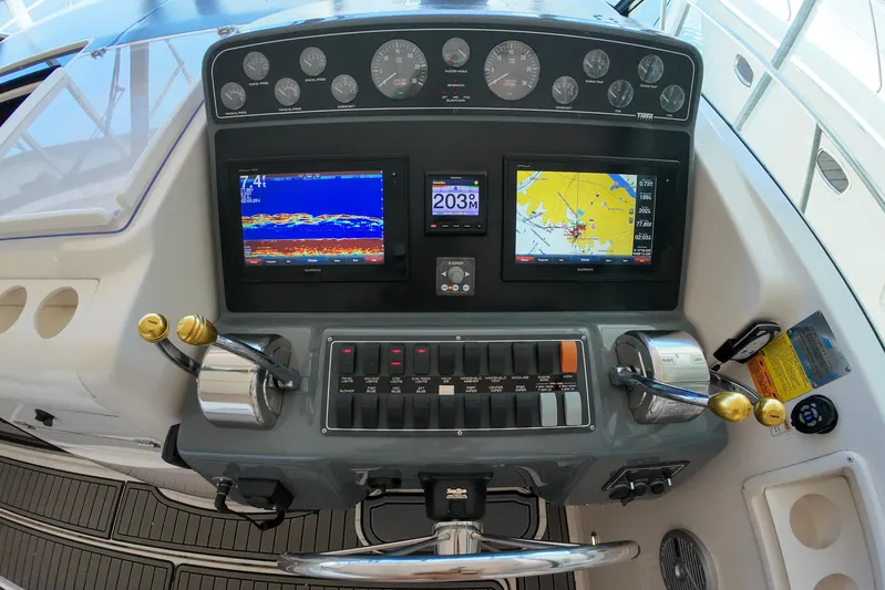 Sun Baked Yacht Photos Pics Control panel of a 1999 Tiara Yachts 3500 Express with navigation displays and gauges.