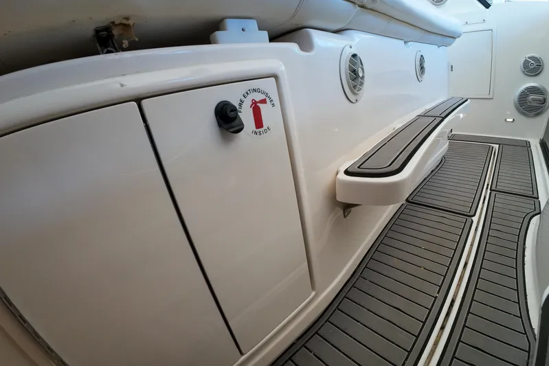 Sun Baked Yacht Photos Pics 1999 Tiara Yachts 3500 Express interior with fire extinguisher compartment and non-slip flooring.