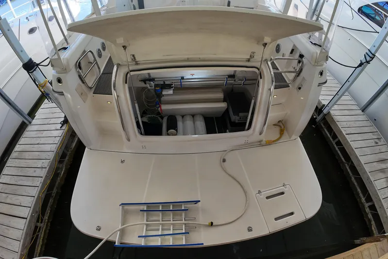 Sun Baked Yacht Photos Pics 1999 Tiara Yachts 3500 Express with open engine compartment at dock.