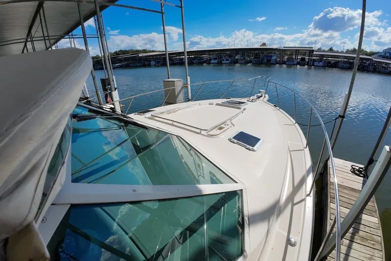 Sun Baked Yacht Photos Pics 1999 Tiara Yachts 3500 Express docked, showcasing sleek design and waterfront view.