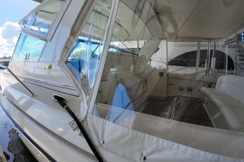 Sun Baked Yacht Photos Pics 1999 Tiara Yachts 3500 Express, interior view with seating and windows, docked on a sunny day.