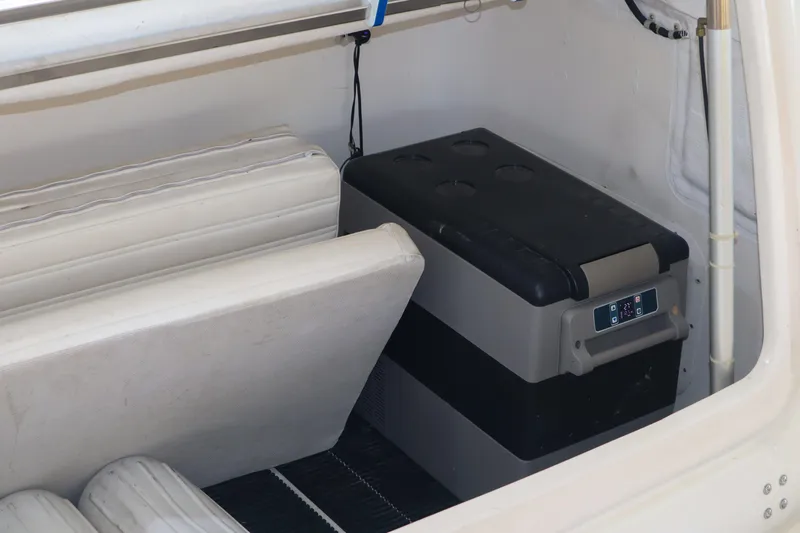 Sun Baked Yacht Photos Pics 1999 Tiara Yachts 3500 Express interior with storage and cooler.