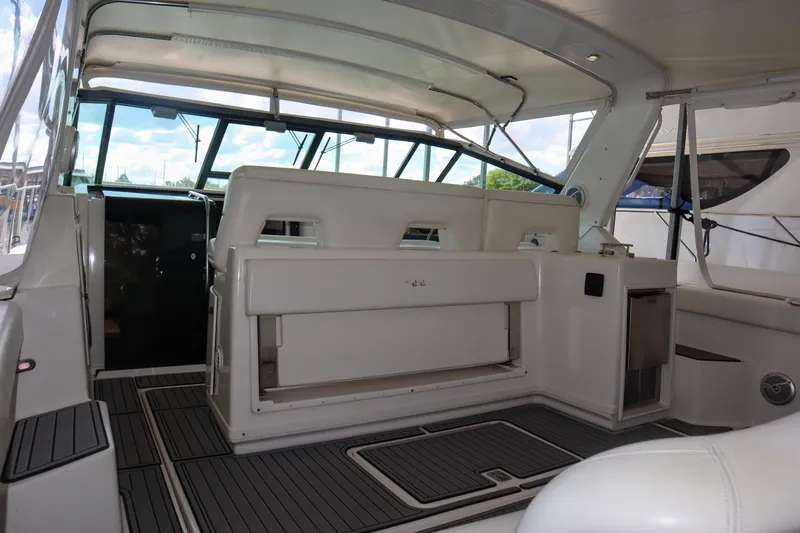 Sun Baked Yacht Photos Pics 1999 Tiara Yachts 3500 Express interior with seating and helm, showcasing luxury design.