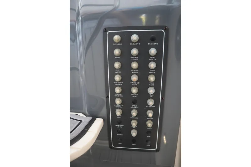 Sun Baked Yacht Photos Pics Control panel of a 1999 Tiara Yachts 3500 Express, featuring various switches and buttons.