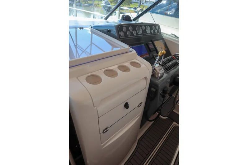Sun Baked Yacht Photos Pics 1999 Tiara Yachts 3500 Express helm with controls and navigation instruments.