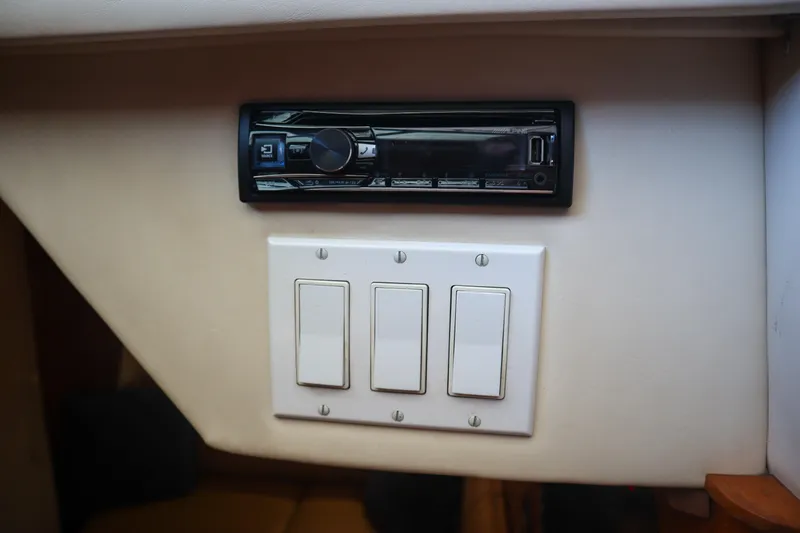 Sun Baked Yacht Photos Pics 1999 Tiara Yachts 3500 Express interior with stereo and light switches.