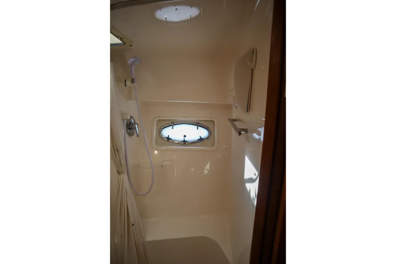Sun Baked Yacht Photos Pics Shower area in 1999 Tiara Yachts 3500 Express with porthole and fixtures.
