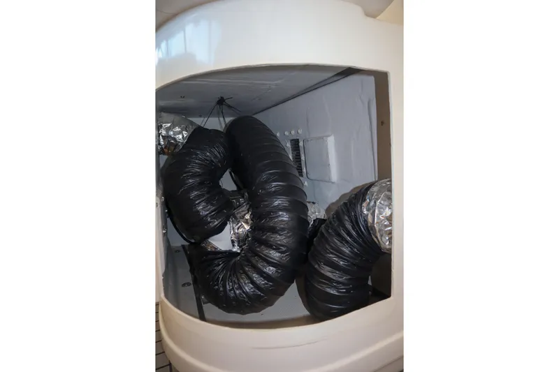 Sun Baked Yacht Photos Pics Engine compartment of a 1999 Tiara Yachts 3500 Express with ventilation ducts.