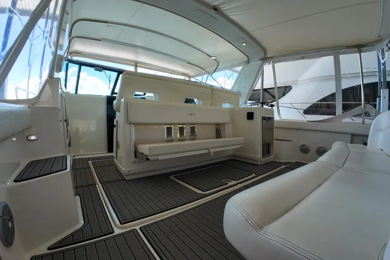 Sun Baked Yacht Photos Pics 1999 Tiara Yachts 3500 Express interior with white seating and modern design.