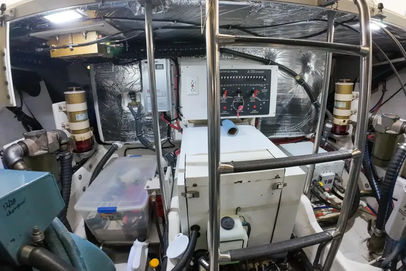 Sun Baked Yacht Photos Pics Engine room of a 1999 Tiara Yachts 3500 Express, featuring control panel and equipment.