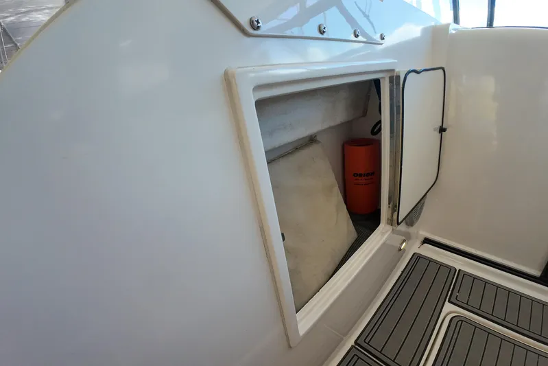 Sun Baked Yacht Photos Pics Storage compartment on a 1999 Tiara Yachts 3500 Express boat, featuring a safety equipment container.