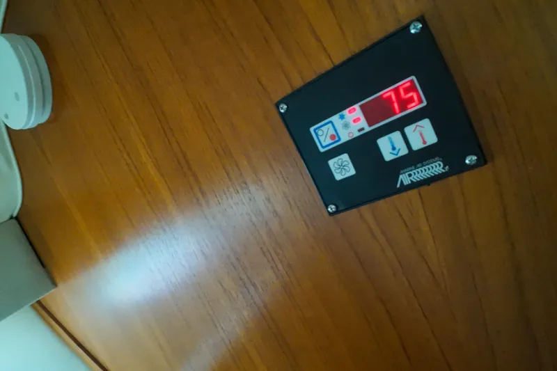 Sun Baked Yacht Photos Pics Control panel on 1999 Tiara Yachts 3500 Express, displaying temperature setting at 75 degrees.