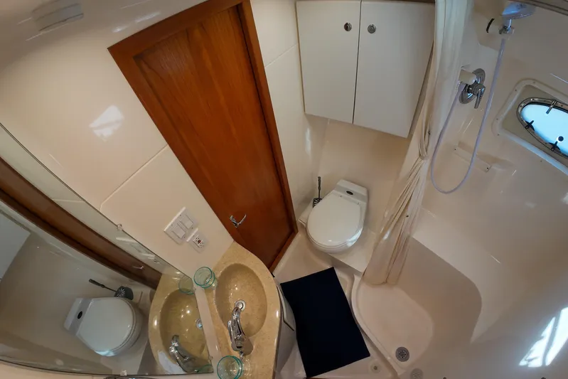 Sun Baked Yacht Photos Pics 1999 Tiara Yachts 3500 Express bathroom with shower, sink, and toilet.