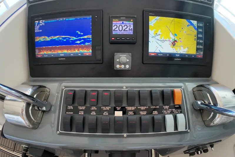 Sun Baked Yacht Photos Pics Control panel of a 1999 Tiara Yachts 3500 Express with navigation displays and switches.
