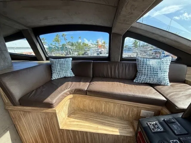 Mia Yacht Photos Pics Interior of a 2009 Custom Contenzo Eagle 90 yacht with brown leather sofa.