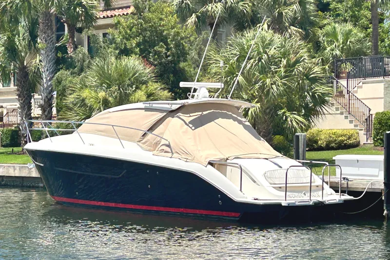 Sea Y'all III Yacht Photos Pics 2014 Pursuit SC 365i Sport Coupe docked near lush greenery.
