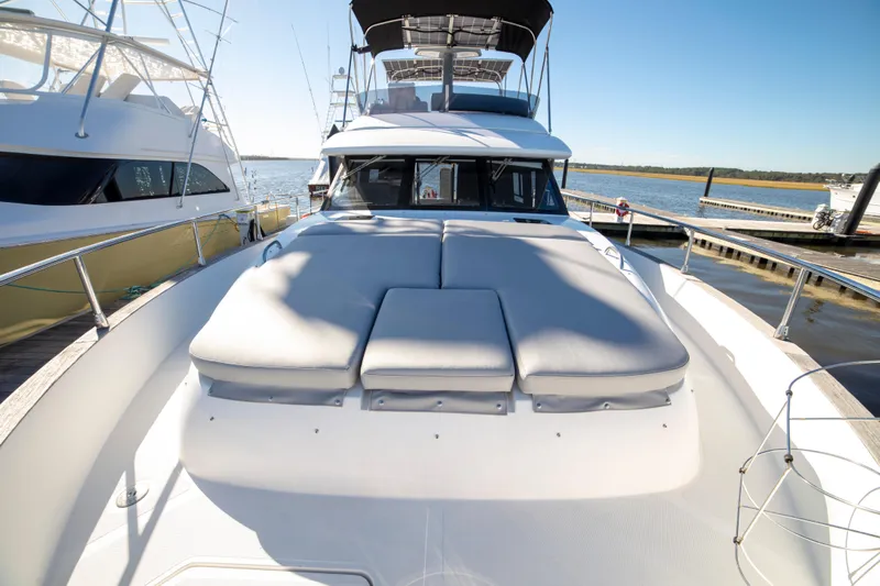 Rumble Bee Yacht Photos Pics 2015 Azimut Magellano 43 yacht with sunbathing cushions, docked at marina.