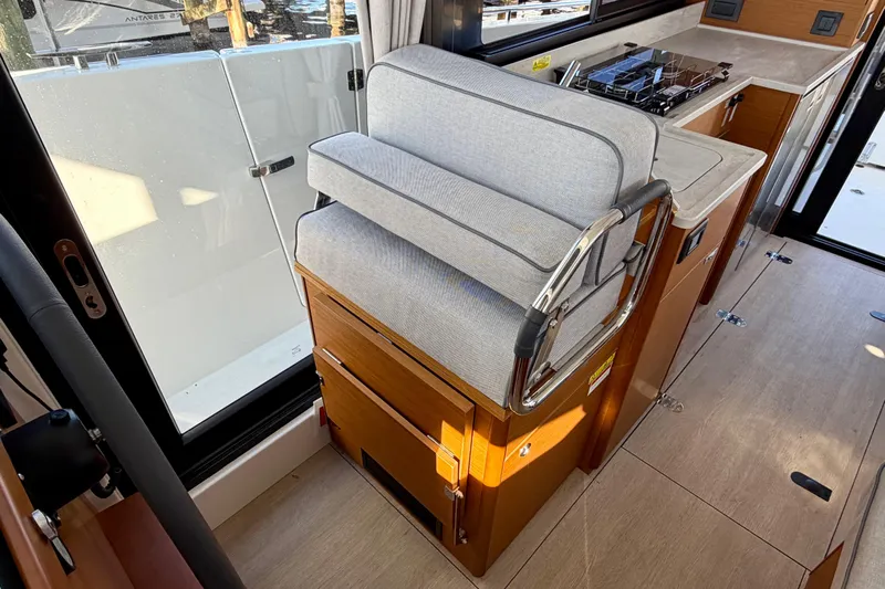  Yacht Photos Pics Interior of 2026 Beneteau Swift Trawler 37 Fly, featuring compact kitchen and seating.
