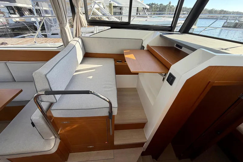  Yacht Photos Pics Interior of 2026 Beneteau Swift Trawler 37 Fly with seating and wooden accents.