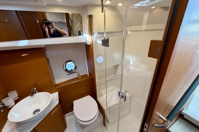  Yacht Photos Pics Luxurious bathroom in 2026 Beneteau Swift Trawler 37 Fly yacht, featuring modern fixtures and elegant design.