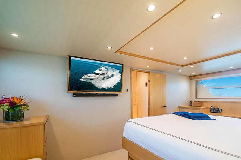 Marybelle Yacht Photos Pics Luxurious bedroom interior of 2017 Viking 82 Cockpit Motor Yacht with TV and modern decor.