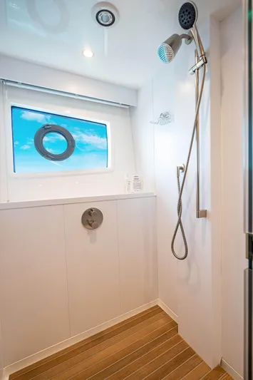 Marybelle Yacht Photos Pics Luxurious shower in 2017 Viking 82 Cockpit Motor Yacht with ocean view window.