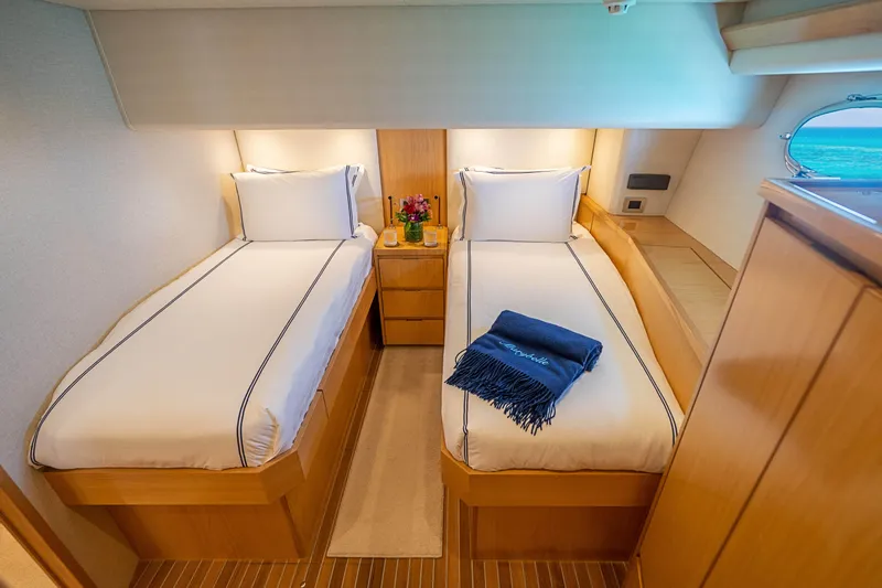 Marybelle Yacht Photos Pics Twin beds in 2017 Viking 82 Cockpit Motor Yacht cabin, with elegant decor and ocean view.