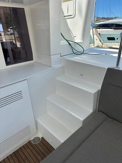 Angels Share Yacht Photos Pics Interior view of 2015 Lagoon 450 F yacht, featuring white steps and seating area.