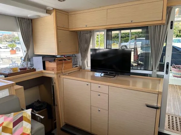 Angels Share Yacht Photos Pics Interior of 2015 Lagoon 450 F yacht with modern cabinetry and TV setup.