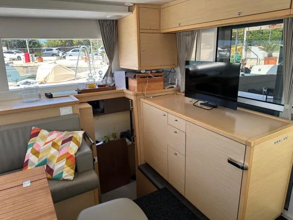 Angels Share Yacht Photos Pics Interior of 2015 Lagoon 450 F yacht with modern furnishings and a TV.