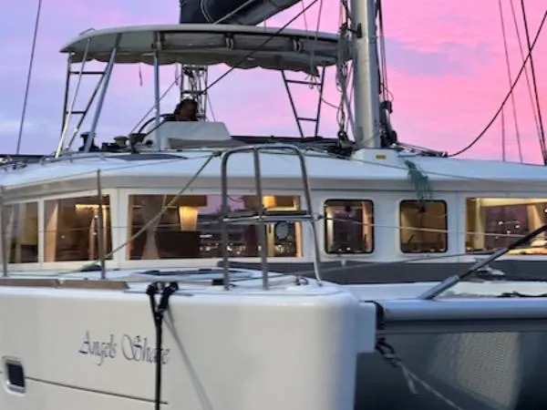 Angels Share Yacht Photos Pics 2015 Lagoon 450 F catamaran at sunset with pink sky background.