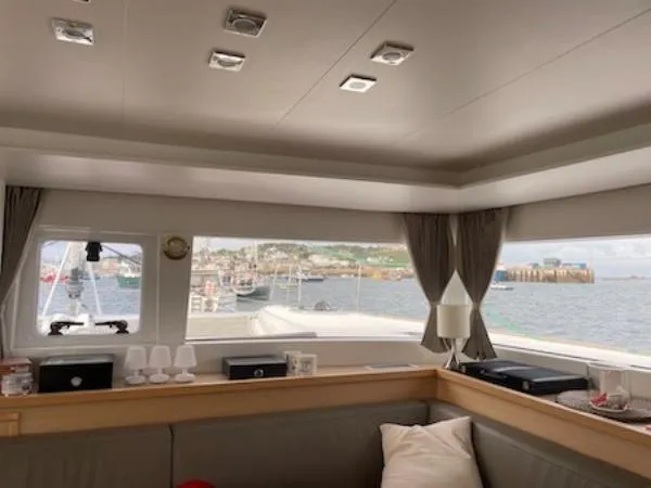 Angels Share Yacht Photos Pics Interior of 2015 Lagoon 450 F catamaran with harbor view through large windows.