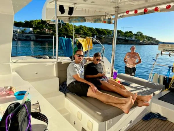 Angels Share Yacht Photos Pics People relaxing on a 2015 Lagoon 450 F catamaran, enjoying a sunny day at sea.