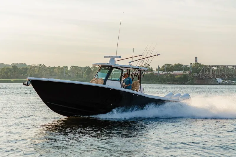  Yacht Photos Pics 2024 Caymas 341 CC boat cruising on a river with fishing rods.