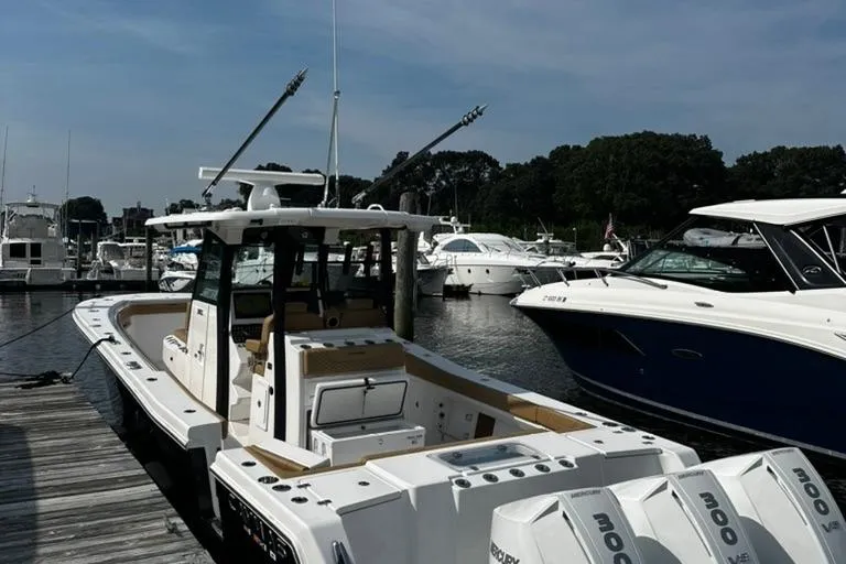  Yacht Photos Pics 2024 Caymas 341 CC boat docked at marina, surrounded by other boats.