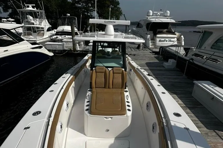  Yacht Photos Pics 2024 Caymas 341 CC boat docked, featuring sleek design and advanced Garmin navigation system.
