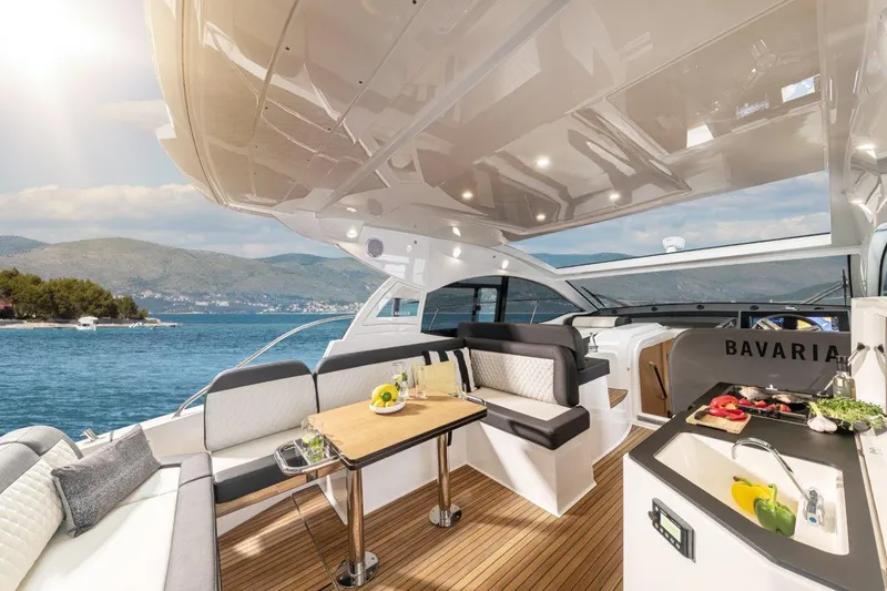 Inventory Clearance Yacht Photos Pics Luxurious 2023 Bavaria SR41 COUPE yacht interior with elegant seating and dining area.
