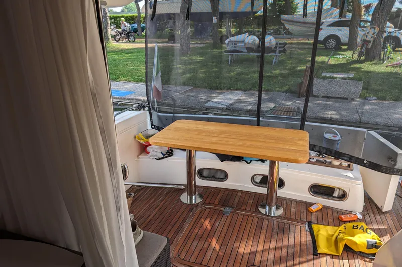  Yacht Photos Pics 1998 Princess 52 Flybridge Motor Yacht interior with wooden table and outdoor view.