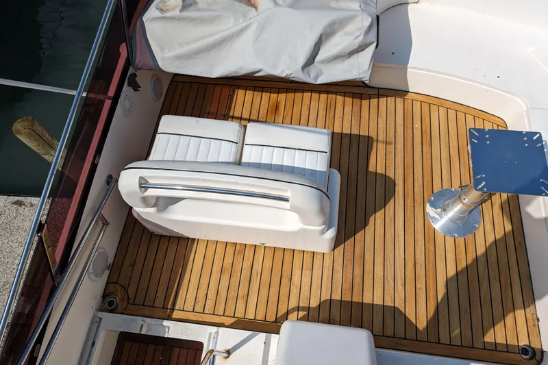  Yacht Photos Pics 1998 Princess 52 Flybridge Motor Yacht deck with white seating and wooden flooring.