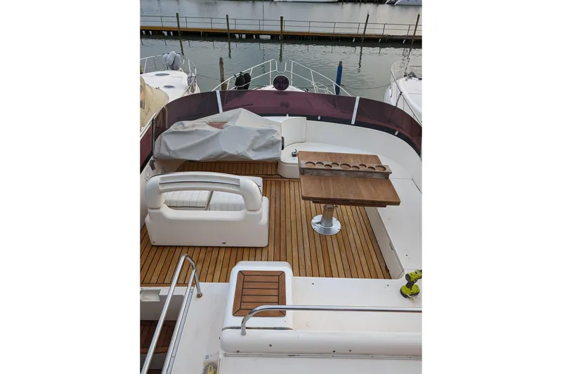  Yacht Photos Pics Flybridge deck of 1998 Princess 52 Motor Yacht with seating and wooden table.