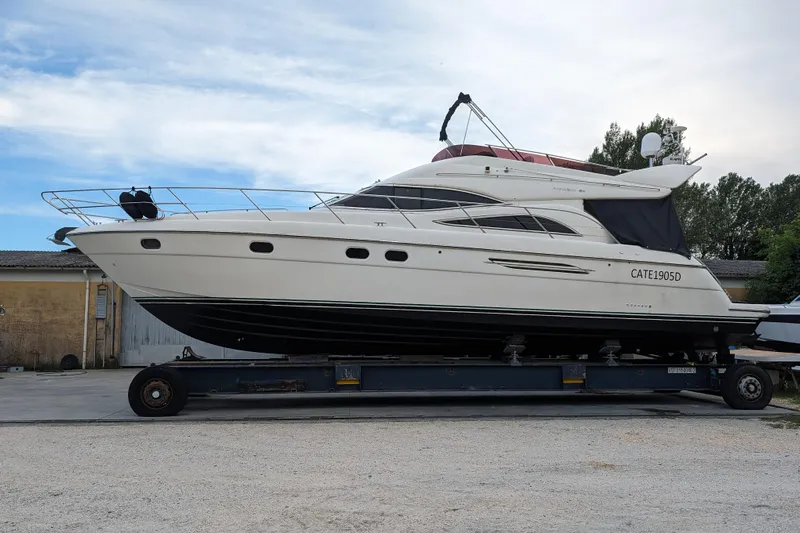  Yacht Photos Pics 1998 Princess 52 Flybridge Motor Yacht on trailer, side view, outdoors.