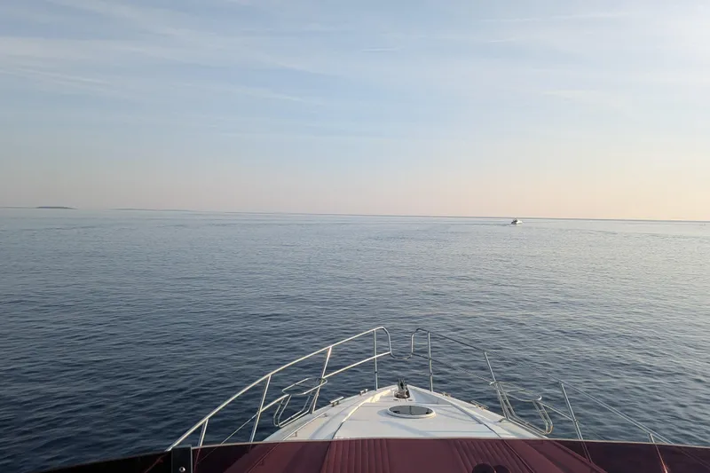  Yacht Photos Pics Bow view of 1998 Princess 52 Flybridge Motor Yacht on calm sea.