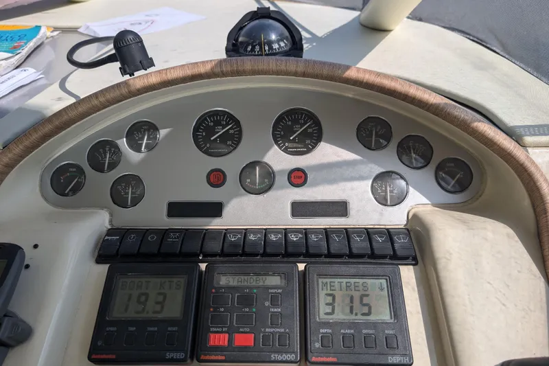  Yacht Photos Pics Control panel of a 1998 Princess 52 Flybridge Motor Yacht, displaying speed and depth gauges.