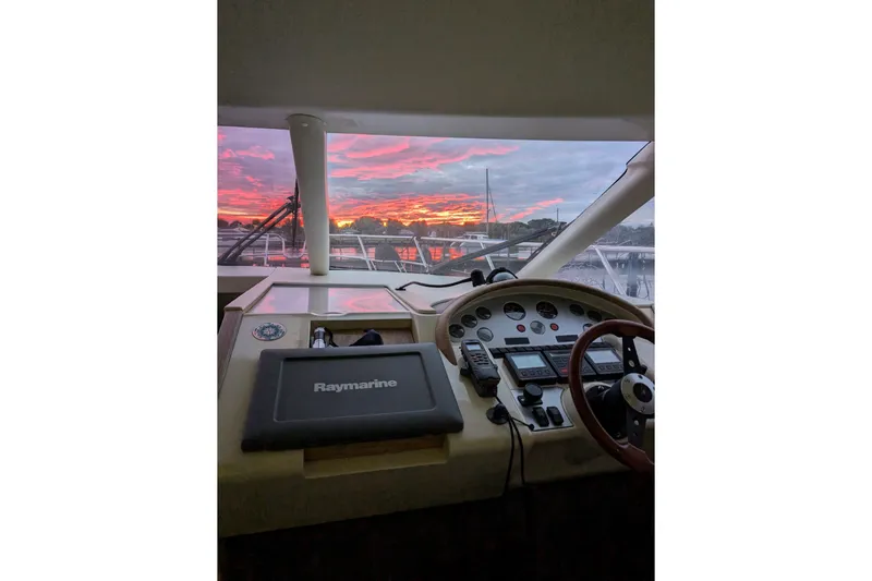  Yacht Photos Pics Helm of 1998 Princess 52 Flybridge Motor Yacht at sunset, featuring Raymarine navigation.